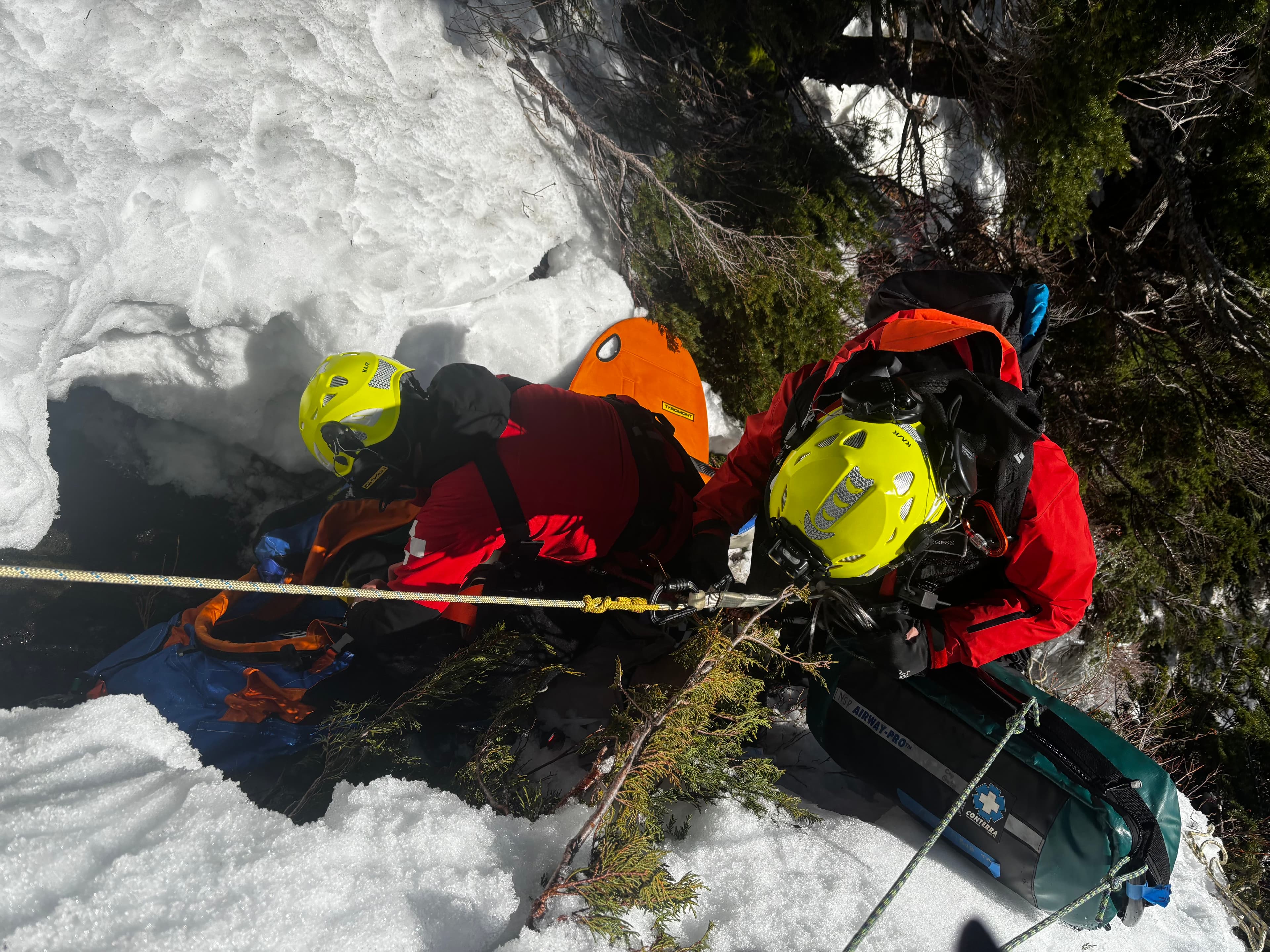 SAR technician rappelling in steep terrain